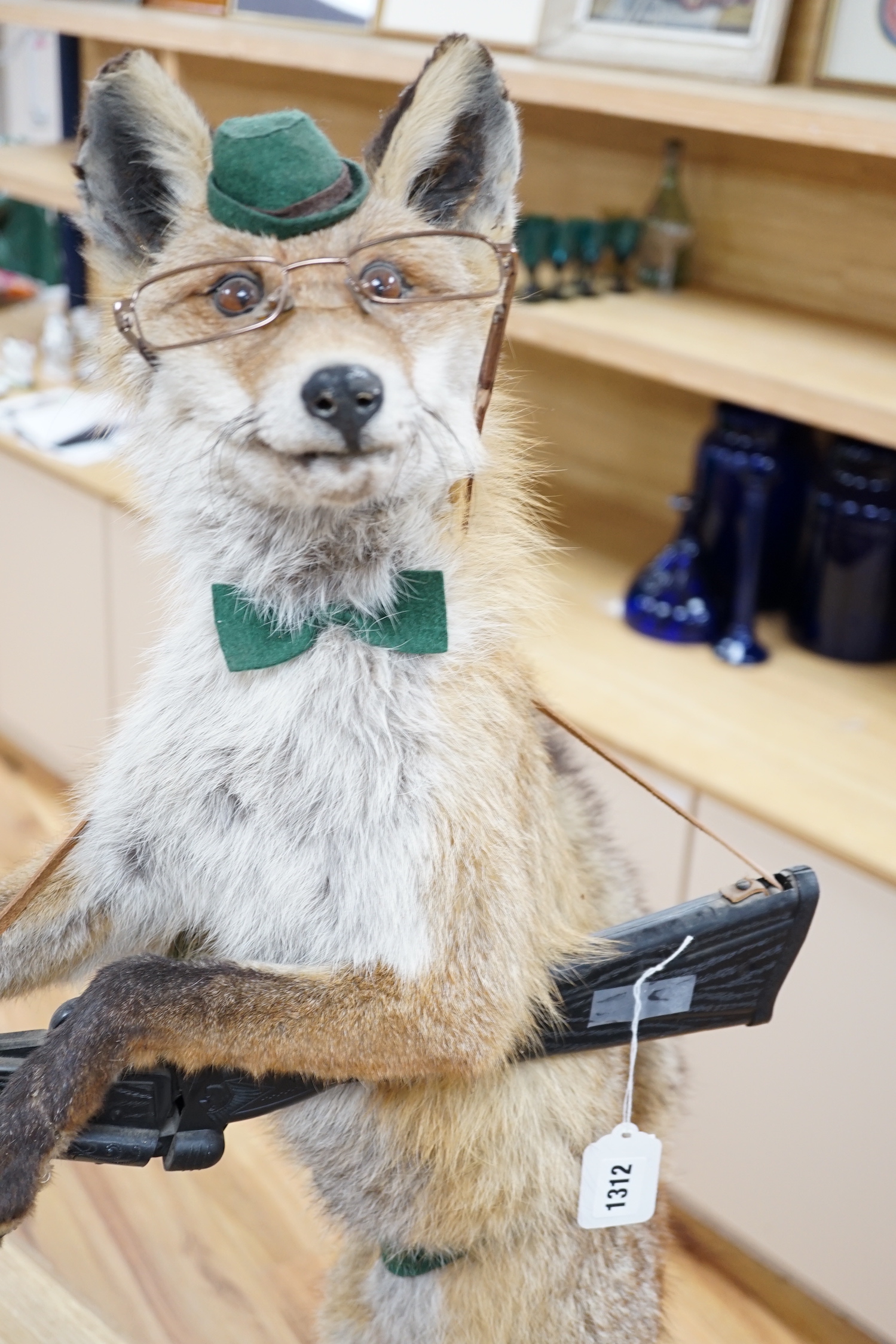 A novelty taxidermy fox group, 100cm high